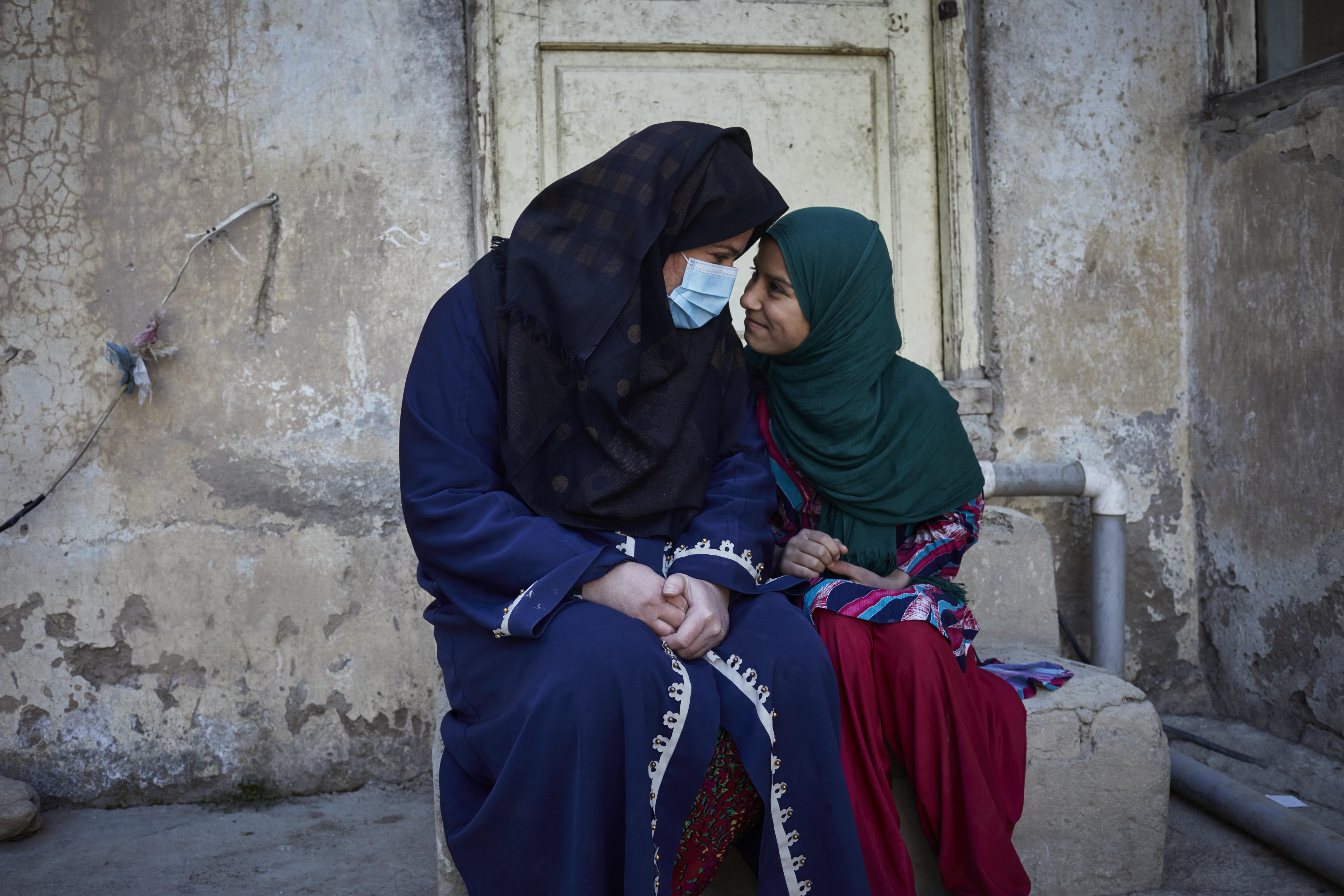 Farishta*, a 28-year-old widow and mother of two, with her daughter in Kabul, Afghanistan.
