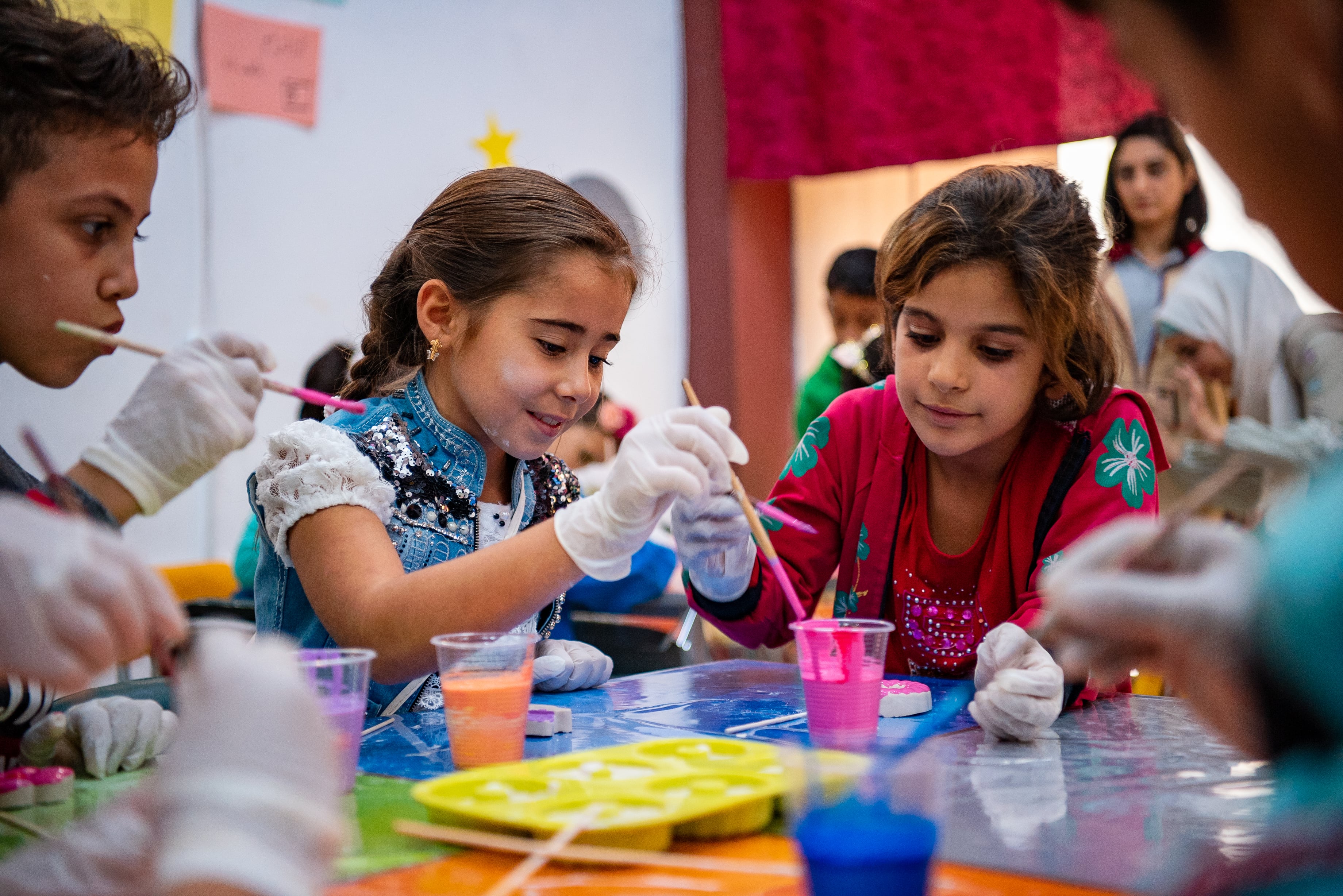Syrian children previously displaced by war in Aleppo learn how to sculpt and paint plaster figurines at a community centre in the Al Sheikh Khuder neighbourhood. ; With support from UNHCR, the UN Refugee Agency, a network of 35 community centres and satellite centres across the governorate of Aleppo are providing protection services to meet the humanitarian needs of vulnerable families affected by war and displacement. 
