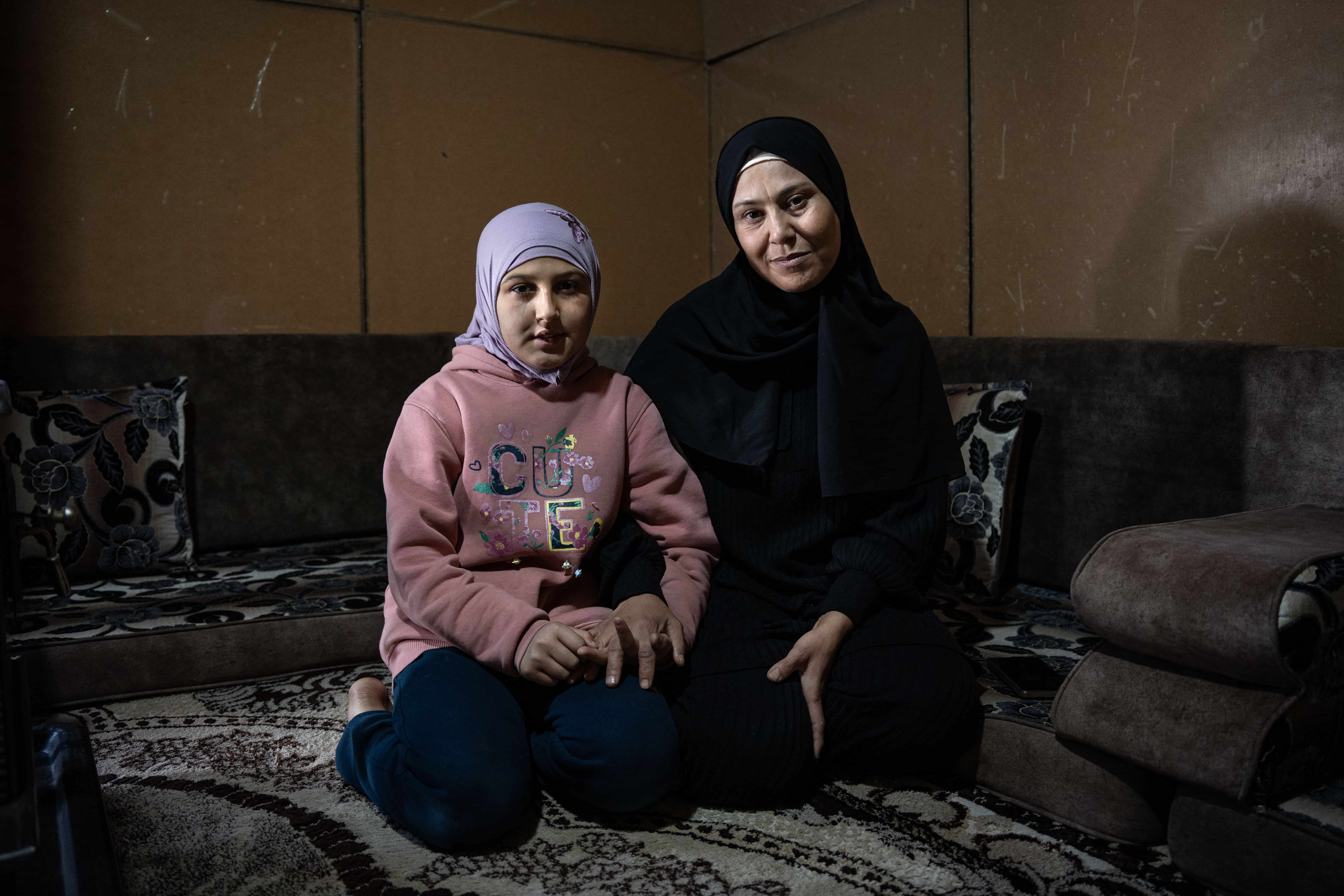 Syrian refugee Hind Al Hamad, 45, and her daughter Qatr, 10, sit in the tent where they have been living since 2016 at a refugee camp in Saadnayel, Lebanon, after fleeing Raqqa, Syria, in 2012, because of the conflict.