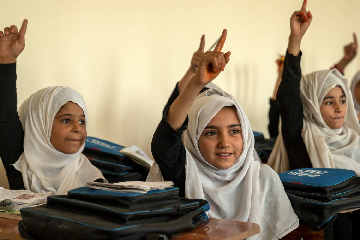 School girls raise their hands in class in Nargarhar Province, Afghanistan