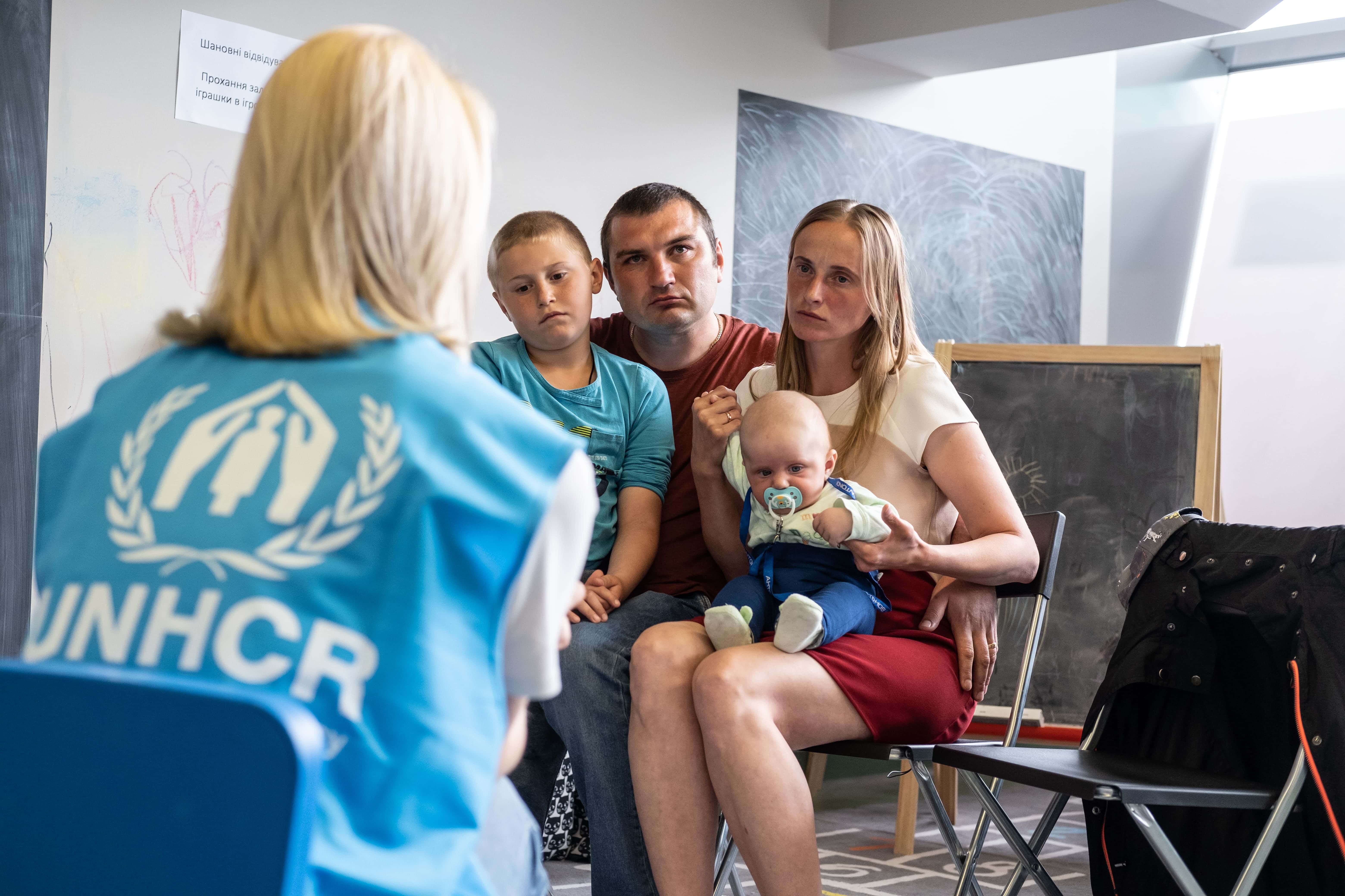 Ukrainian refugees, Andrei and Ludmila, visit UNHCR’s cash enrolment centre in Krakow Tauron Arena to register for cash assistance to cover their basic needs.