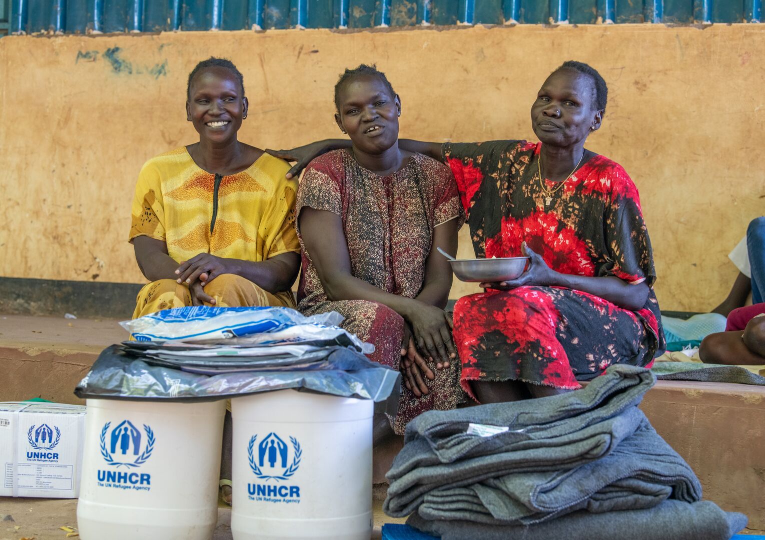 Refugees in Kakuma, Kenya receive essential relief items from UNHCR following heavy rains.