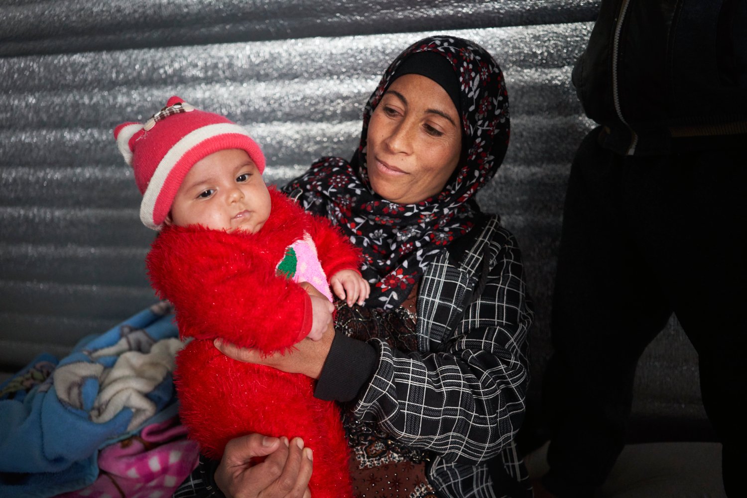 Wardah Alabdallah holds her two-month-old daughter Muna in the family's shelter in Azraq refugee camp, Jordan.