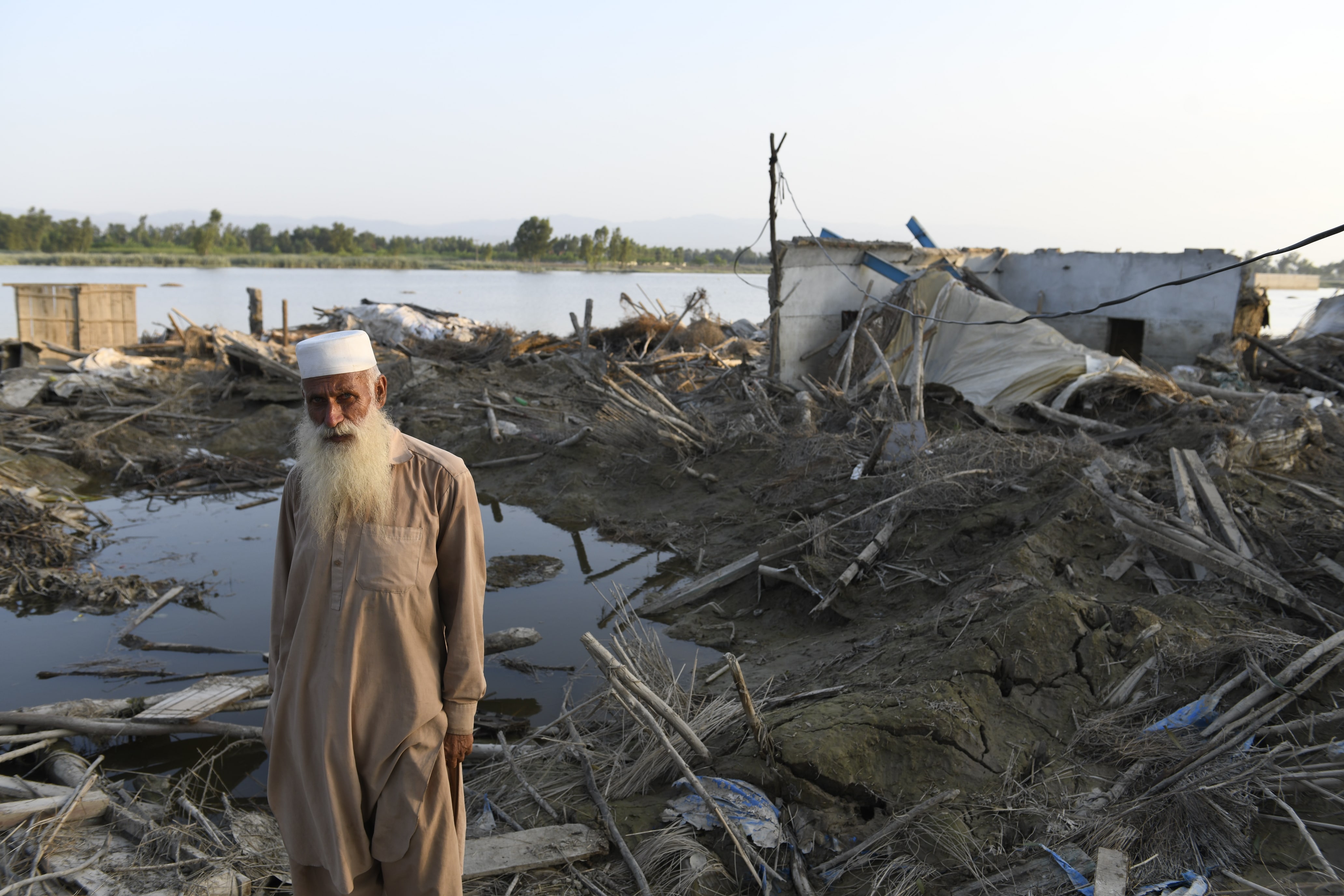 Afghan refugee Bahadur, 60, takes shelter in a UNHCR tent after being displaced by the monsoon flooding in Nowshera District, Khyber Pakhtunkhwa Province.