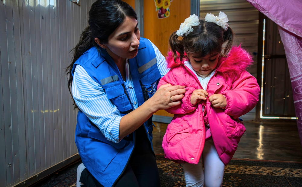 Jordan. Miral, 3, proudly shows her pink winter jacket inside her shelter in Zaatari refugee camp.