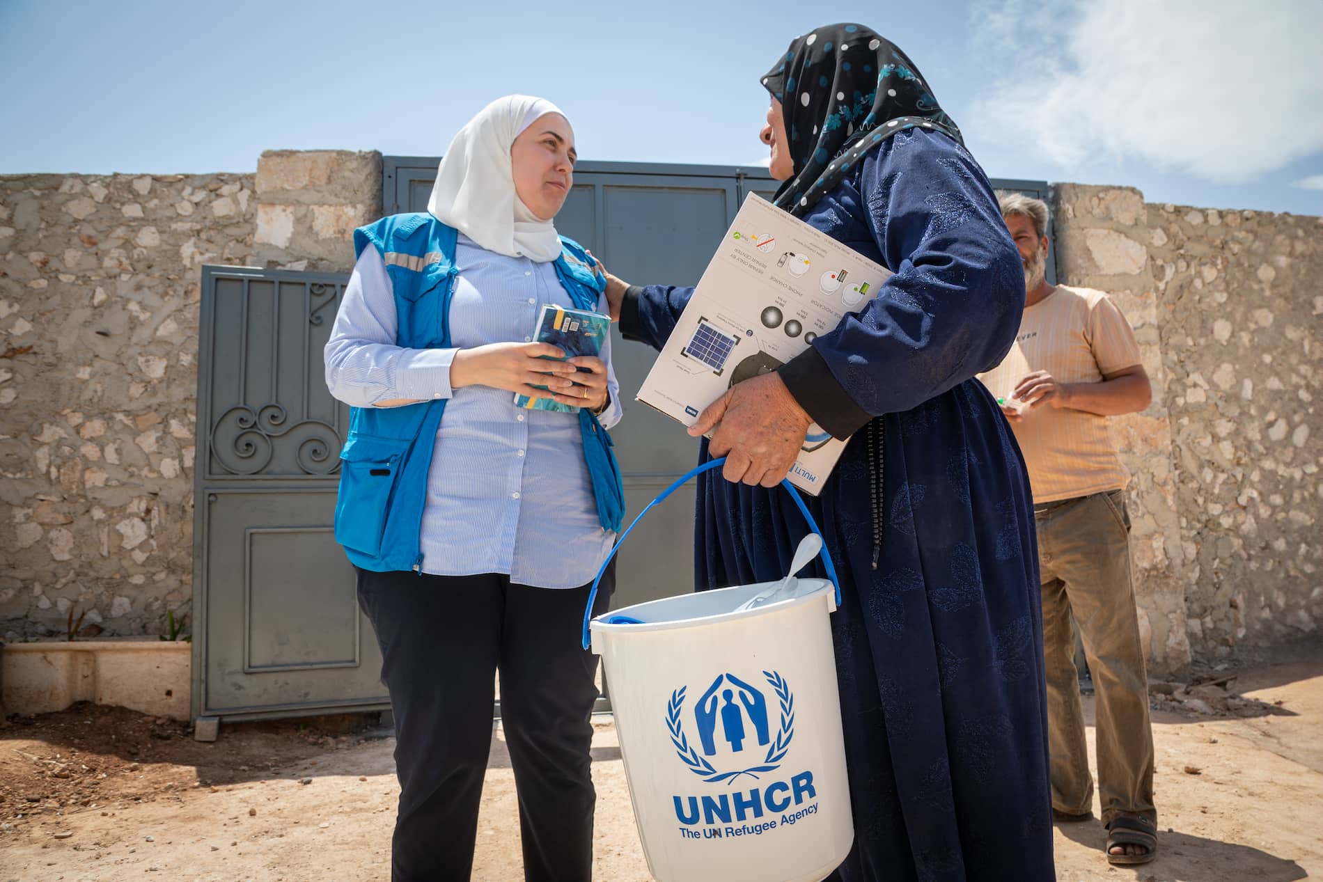 Halloum received a core relief item package that included mattresses, sleeping mats, blankets, kitchen sets, solar lamps, and water containers.