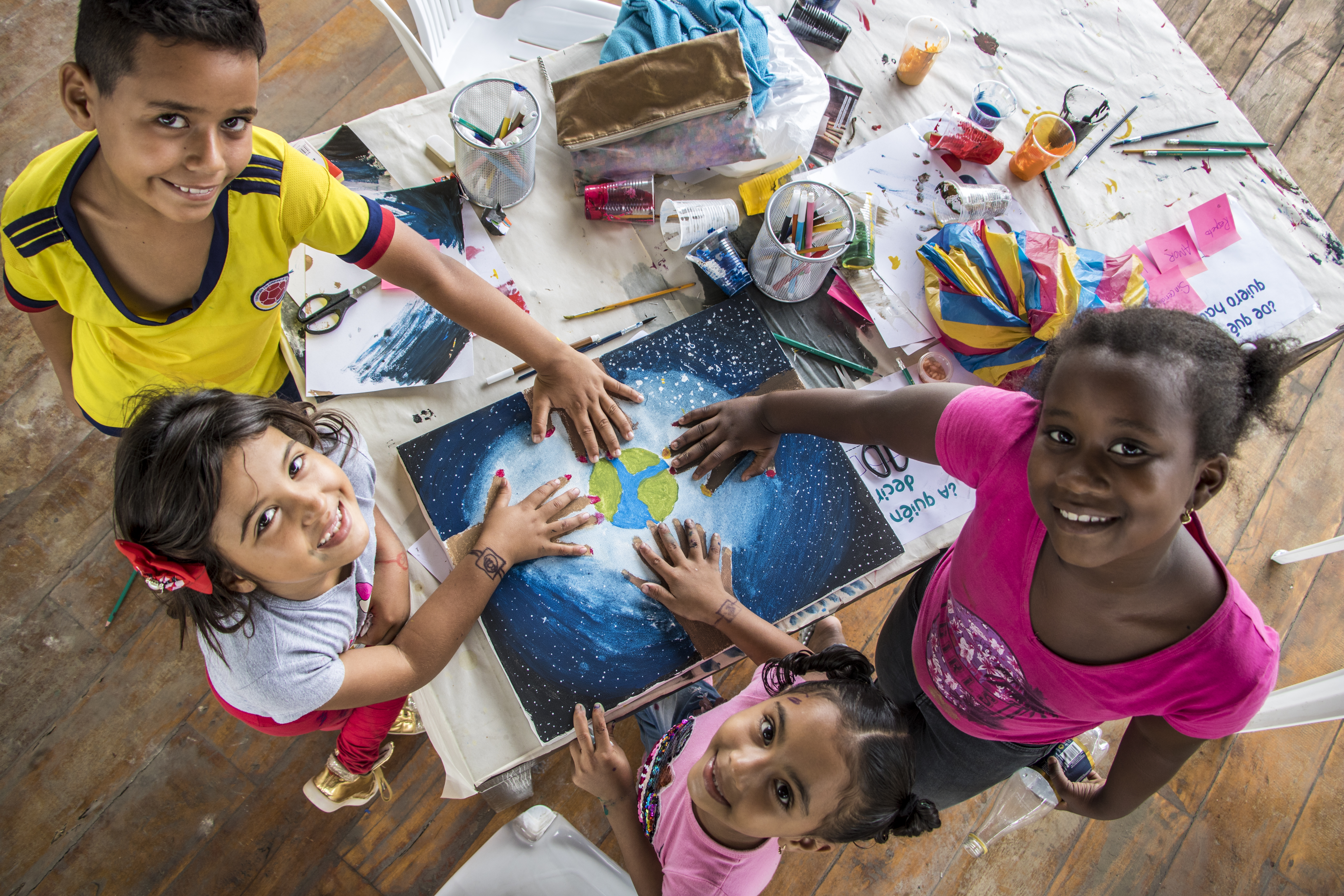 Ecuador. Young Refugees And Locals Paint Together