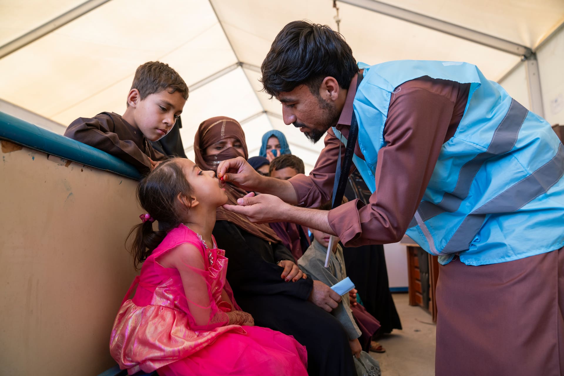 Ayesha, 5, at the UNHCR Encashment Centre, receives a health check-up and vaccination as part of the support provided to help families settle back into life in Afghanistan safely and healthily