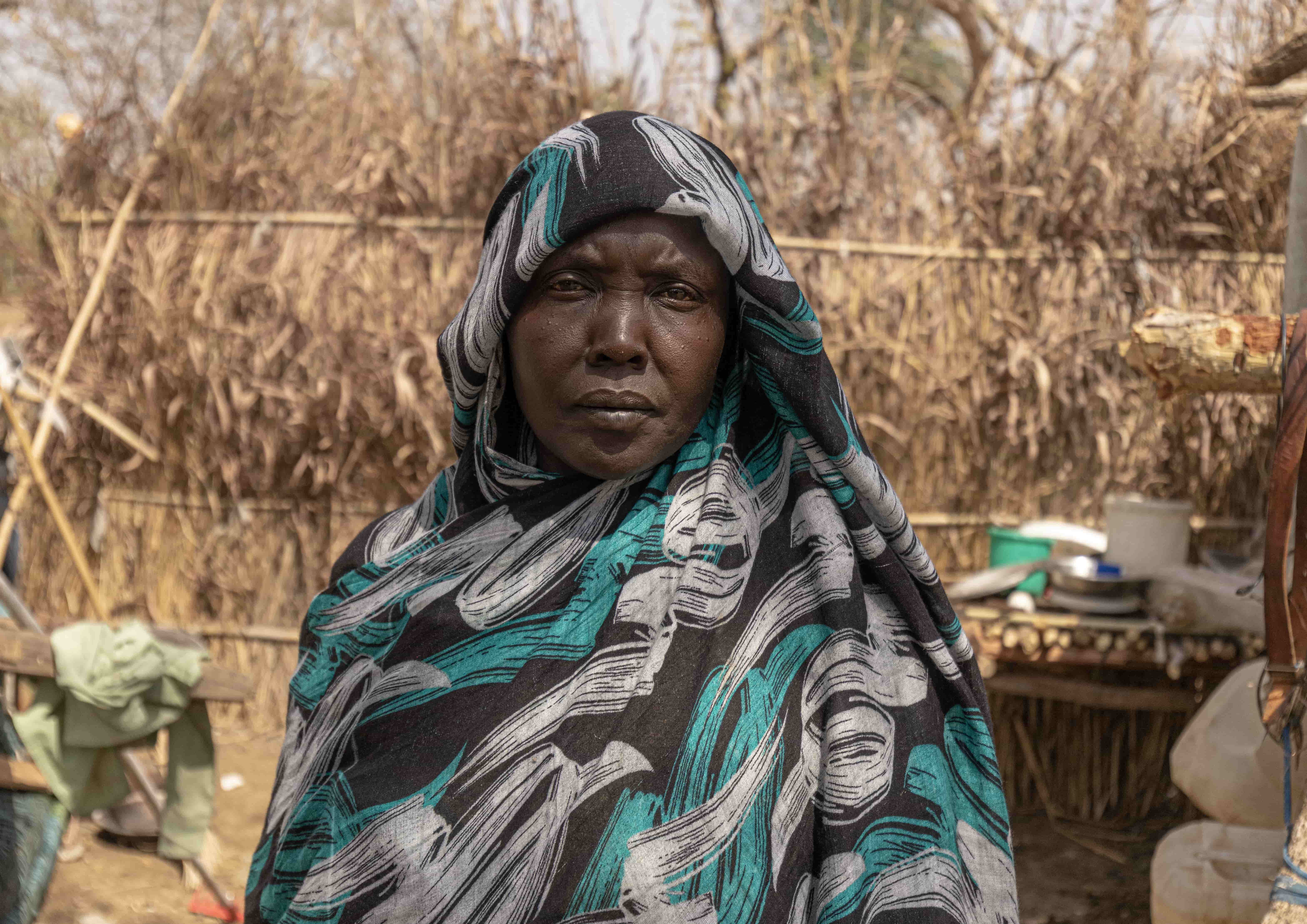 Ethiopia. Hawa, 40, stands in front of her shelter at the Kurmuk transit centre