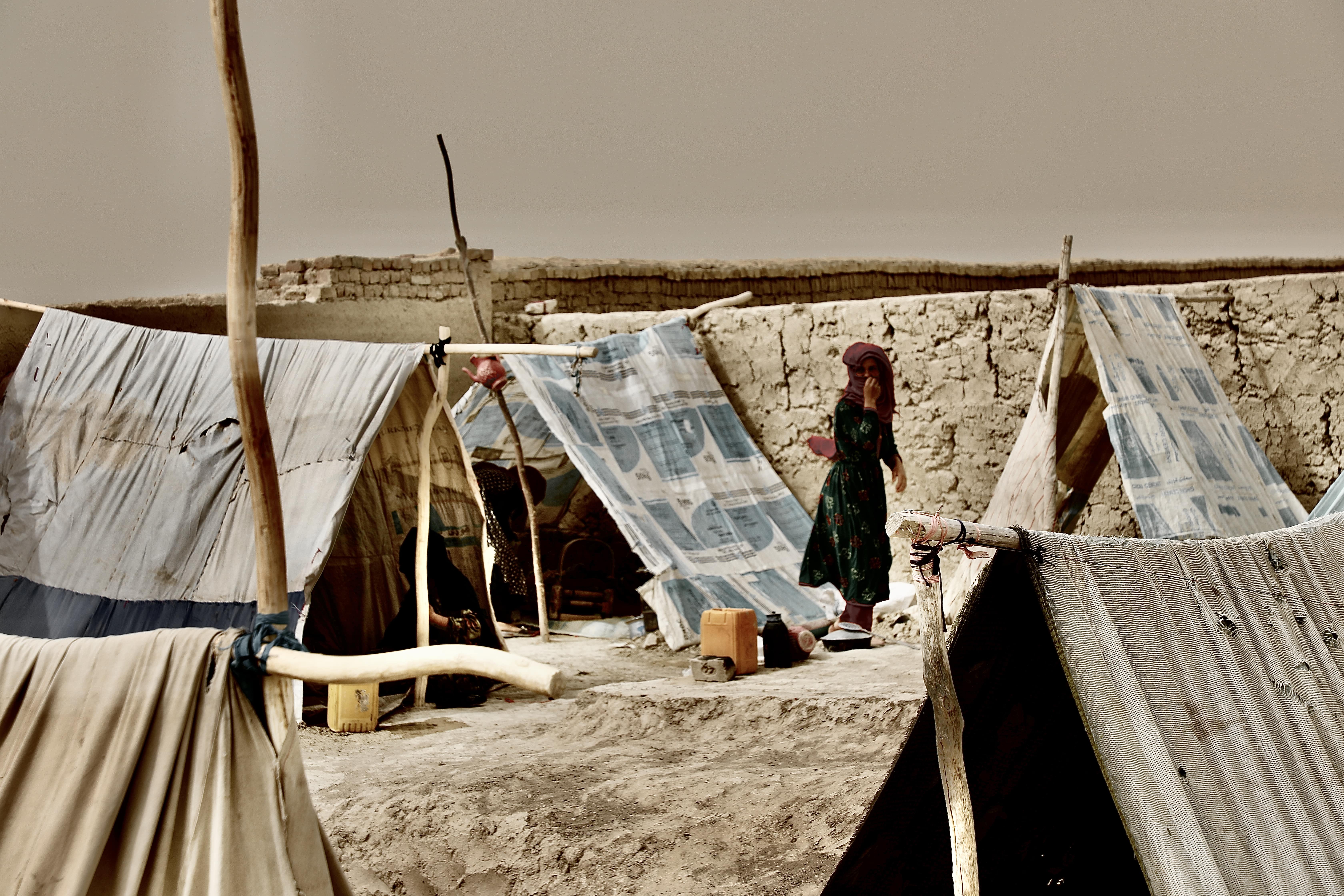 A woman prepares to start a fire to bowl water in an IDP camp in Mazari Sharif.